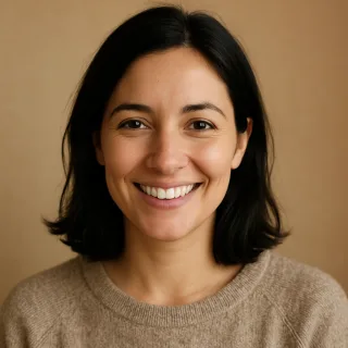 A smiling woman with dark hair in a casual sweater.